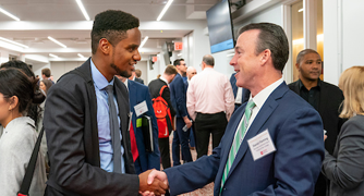 Image of student networking with alumnus.