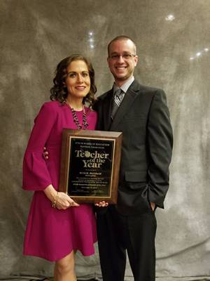 Image of Erin Berthold and Matt Berthold holding the 2018 Teacher of the Year award.