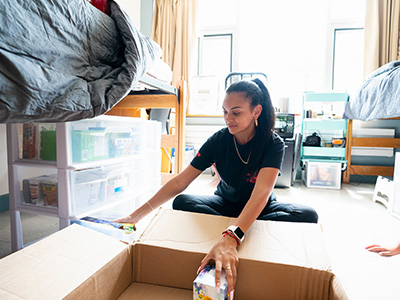 Photo of student unpacking in her residence hall