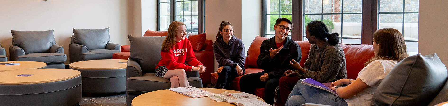 Photo of students socializing in residence hall lounge area