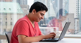 Image of students on a laptop