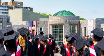 Image of graduates walking to the ceremony site.