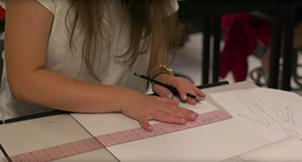 An image of a student working on sketches. 