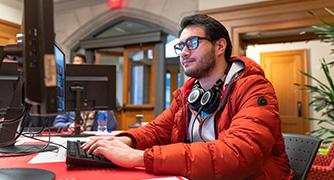 image of student sitting at a computer