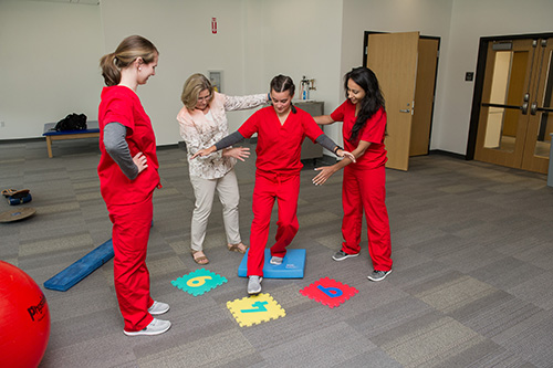 image of  Master of Science Physician Assistant Program working with a patient walking on the foam blocks