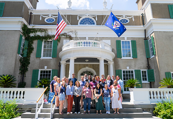 Image of Dr. Woolner and teachers standing outside the FDR home.