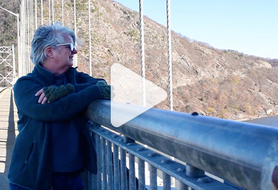 Image of screenshot of film with Lorraine Lein looking out from the Bear Mountain bridge with 