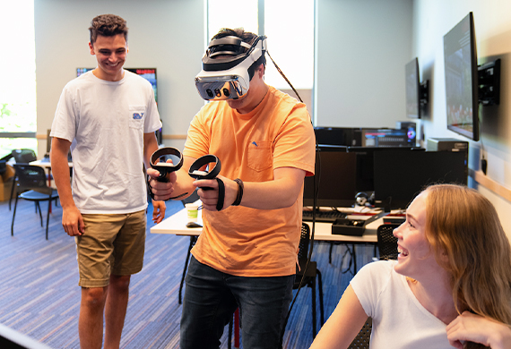 Image of student using a virtual reality headset in the Marketing Lab.