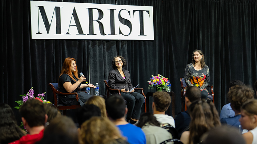 Image of presenters on stage at the Common Read Lecture.