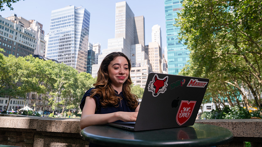 Image of Marist student working on a laptop in Manhattan's Bryant Park.