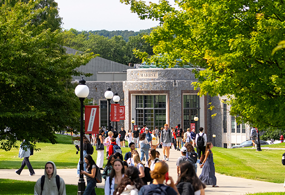 Image of students walking on campus on a beautiful day.