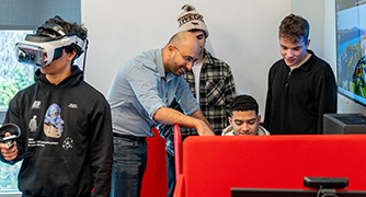 Image of Marist University students working in the Marketing Intelligence Lab with Professor Mohammadali Koorank Beheshti.