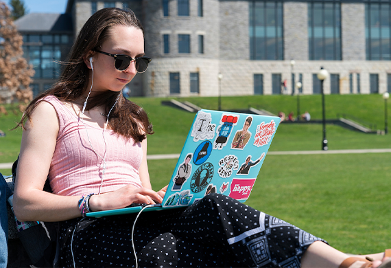 image of marist student listening to music while on her laptop