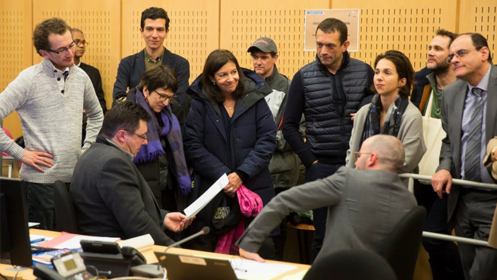 Professor Jay Bainbridge (in baseball cap) prepares for the first homeless street count in Paris with officials, including Mayor Anne Hidalgo