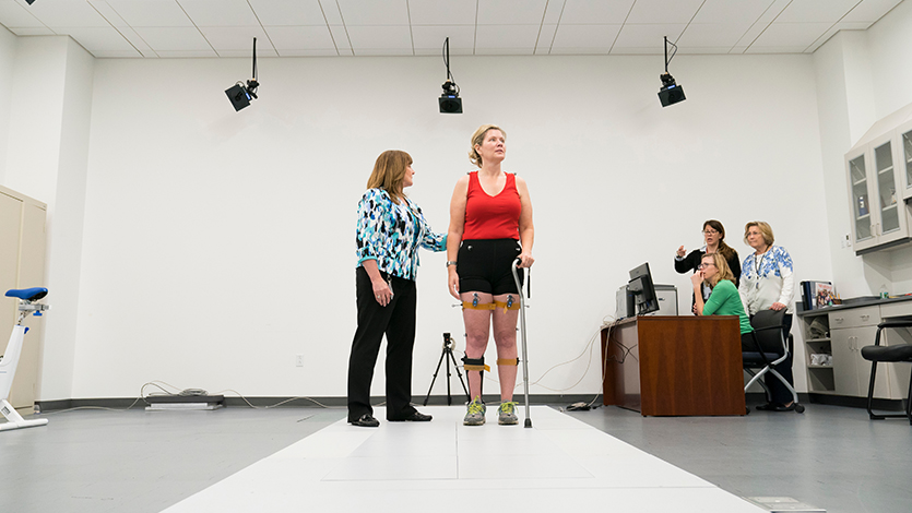 Doctor of Physical Therapy Program faculty work with a patient.