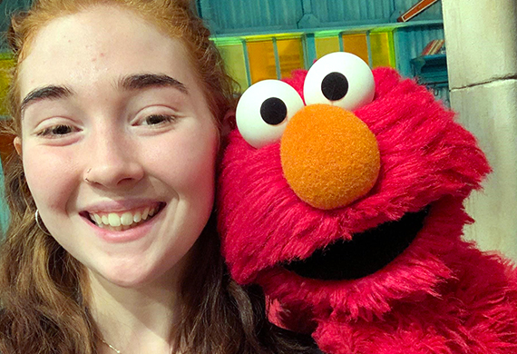 Marist student with Sesame Street puppet Elmo
