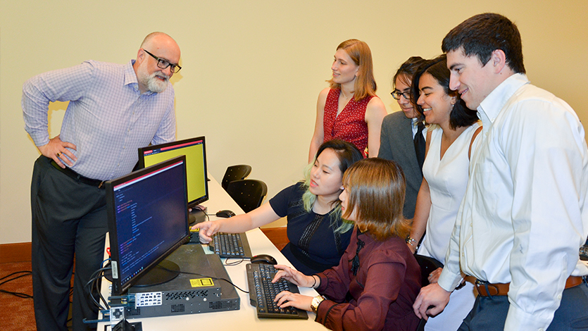 Professor Chris Algozzine with students who helped develop G-TEL mobile application