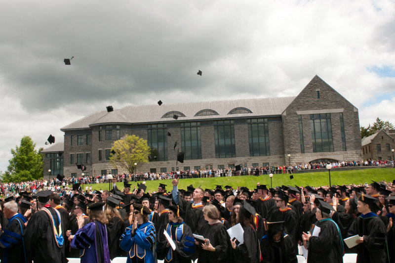 Image of students throwing their graduation caps into the air