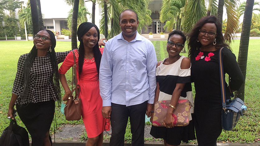 Dr. Eugene Ohu (center) and members of LBS’s Virtual Reality Lab.