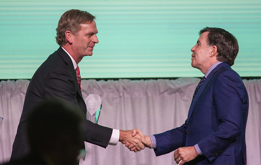 image of Dr. Kevin Weinman, President of Marist College, presents Bob Costas with the Lifetime Excellence in Sports Communication Award.