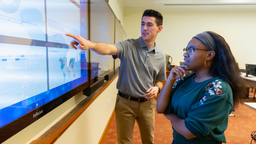 Computer Science students discussing cybersecurity at the Security Operations Center