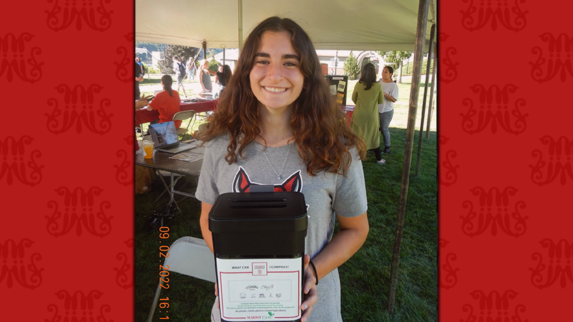 Emily Liguori ’25, Vice President of SGA’s Sustainability Committee holding compost container