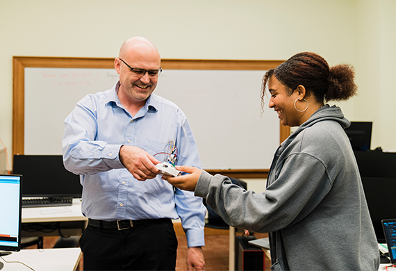 Image of Marist University's Summer Pre-College Robotics professor with a student.