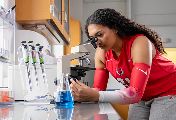 Marist University Image: Vallane Sneva looks into a microscope.