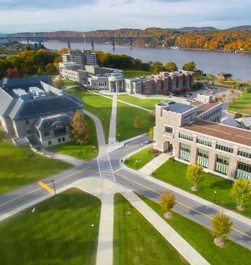 Image of the Marist University campus green with the Hudson River in the background.