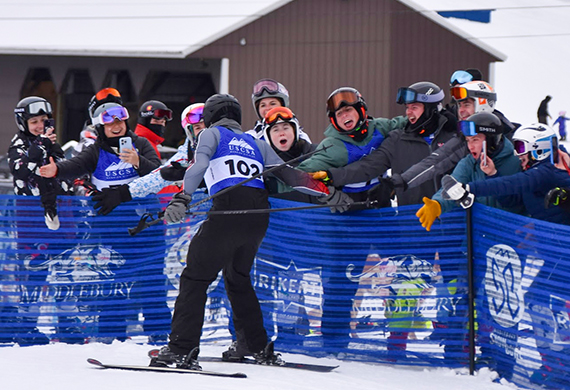 Griffin Barrows ’26 high-fives his teammates after his final ski race. Photo by Laura Lynch.