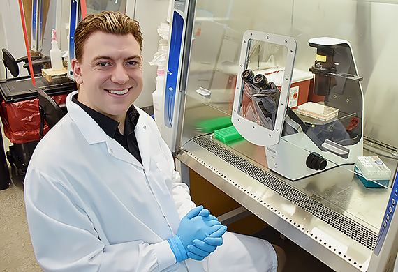 Jonathan monitors the development of human brain cells under the microscope at the Picower Institute for Learning and Memory (Tsai Laboratory), MIT. Photo courtesy of Jonathan Palmiero ’26.
