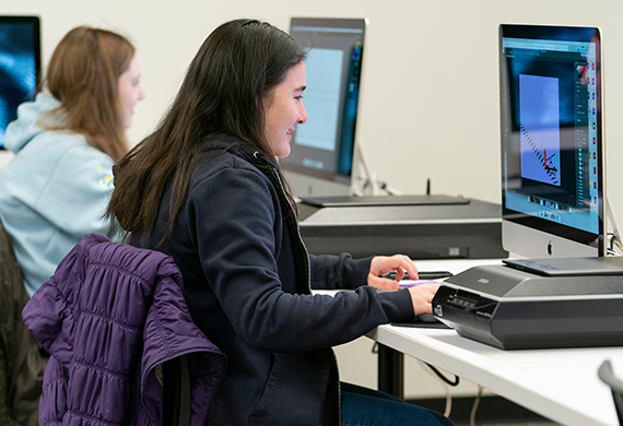 Image of a Marist University UX Design minor working on a computer.