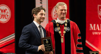 Image of a Marist University honors student receiving an award at the academic achievement ceremony.