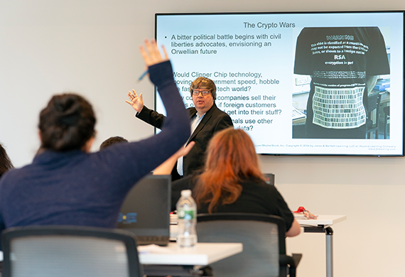 Image of Marist University professor Casimer DeCusatis teaching in class.