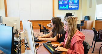 Image of two students working in the Investment Center