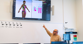 image of a professor pointing at a monitor