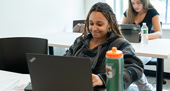 image of student working on a laptop