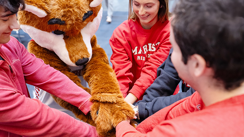 Image of Marist students and Frankie the Fox prepare for this year’s Day of Giving.