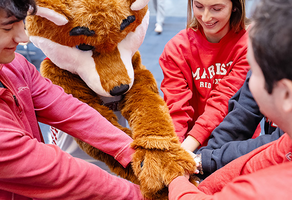 Image of Marist students and Frankie the Fox prepare for this year’s Day of Giving.