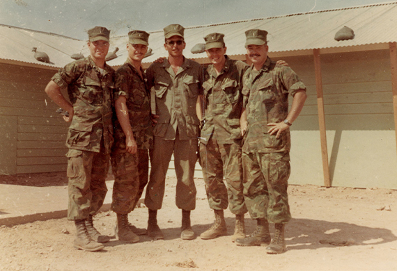 ​ Marist and the College is now preparing to pay tribute to him later this week at McCann Arena.  Kuffner, who roomed with his twin brother Dan during their sophomore year, graduated in May of '68. In September, Bill entered Officer Candidate School, embarking on a demanding 23-week training program to prepare him for the role of a Marine infantry platoon commander. By August 1969, he was stationed in South Vietnam, leading his own unit in the 7th Motor Transport Battalion, in support of the 3rd Marine Division's combat operations.  Marist Alumni Connect In Peace & War  Service was a defining characteristic of Marist's Class of 1968. Several graduates, including Kuffner, were deployed to South Vietnam. While there, by sheer coincidence, Kuffner and a few other recent Marist alumni were stationed in the same area simultaneously. This remarkable meeting took place in August 1969 when Kuffner and four fellow Marist officers were assigned to the vicinity near the Demilitarized Zone.   Marist alumni in Quang Tri, Vietnam, September 1969: From left, Bill Kuffner '68, Mike Santimauro '68, John Casserly '67, Brendan Burke '68, and Jim Barnes '68. Photo courtesy of Marist Archives.  ​