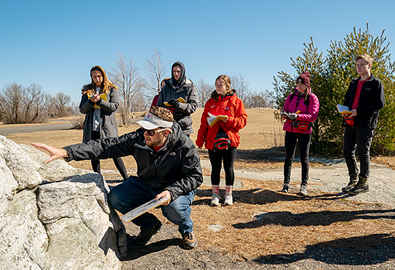 Dr. Zion Klos teaches environmental science students at Minnewaska State Park. Photo by Carlo de Jesus/Marist University. 