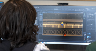 Marist University Summer Pre-College Game Design working on a computer.