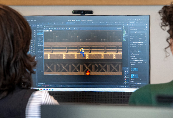 Image of students working on a computer game.