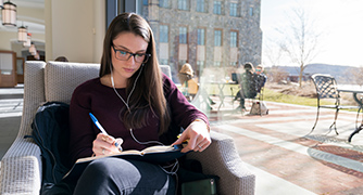 Photo of student studying in library