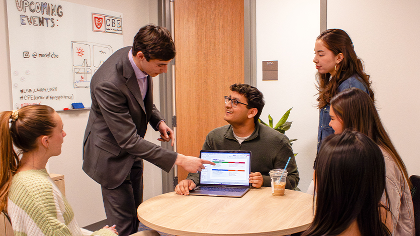 Image of Matt Poillucci ’28 points to his strategic business plan while collaborating with fellow SOM students. Photo by Alyssa Walrad/Marist University.