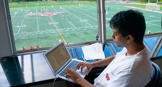 Image of a sports communication student covering an athletic event.