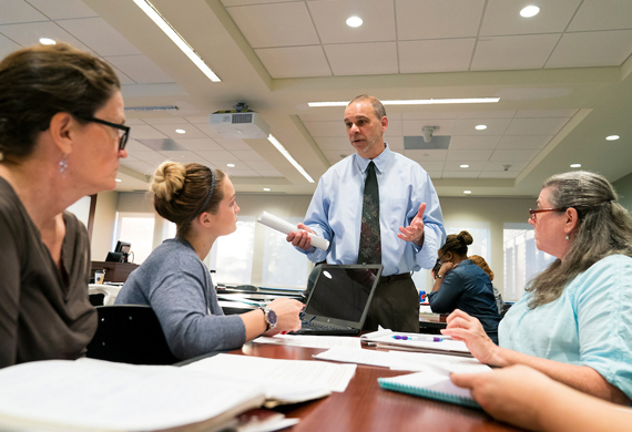 Image of adult students in classroom discussion.