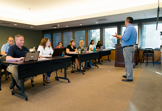 Image of adult students during a classroom discussion.