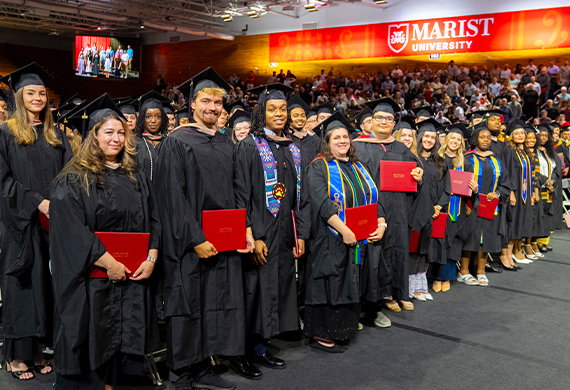 Image of students with their diplomas at the Graduate Commencement ceremony.