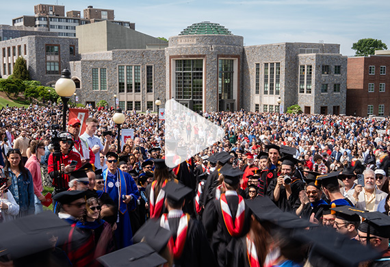 Image of students processing onto the Campus Green with 